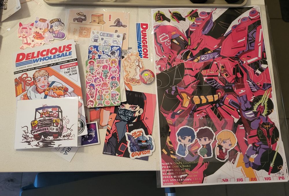 various items i bought - prints, a fanzine, a poster, a pin, many stickers
