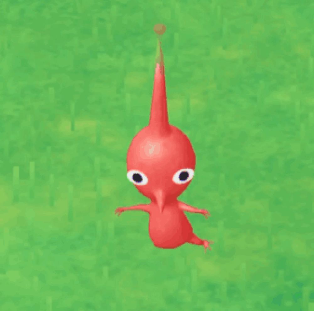 a red cartoon character is standing on a green grass field