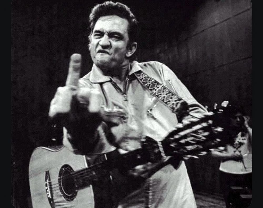 Picture of Johnny Cash throwing the middle finger birdie. 