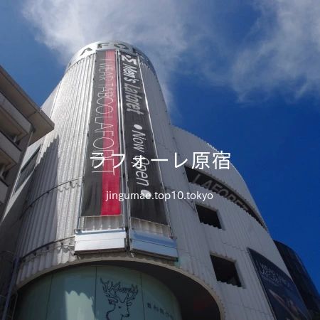 2010 年 8 月 7 日 13 時 03 分に、入口近くまで近寄り、見上げながら「ラフォーレ原宿」を撮影しました。建物壁面に掲示された「I WEAR TABOO. LAFORET」と書かれたメッセージ広告も写っています。この広告は、「ラフォーレはタブーを提案し、それを受け入れる場所であるべき」というコンセプトのもと、「I wear TABOO」というメッセージが採用されました。