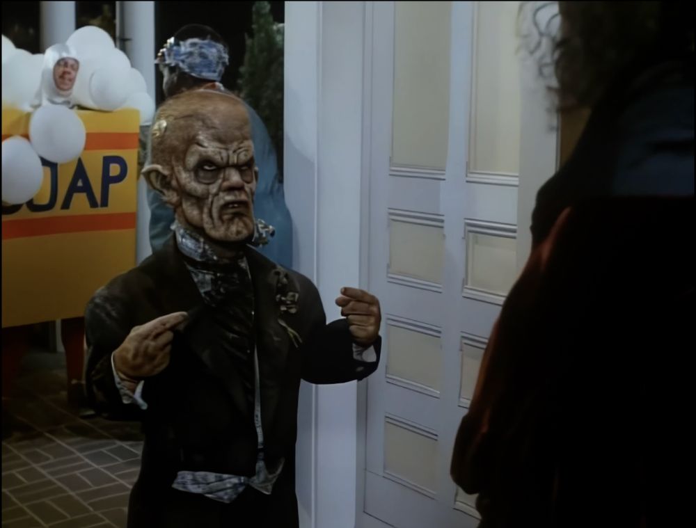 I'm not even sure where to begin. It's a photo of a little person zombie/demon/vampire dude who gained entrance into a Halloween party by snapping his fingers and pointing at himself. The Fonz himself couldn't have done it better.