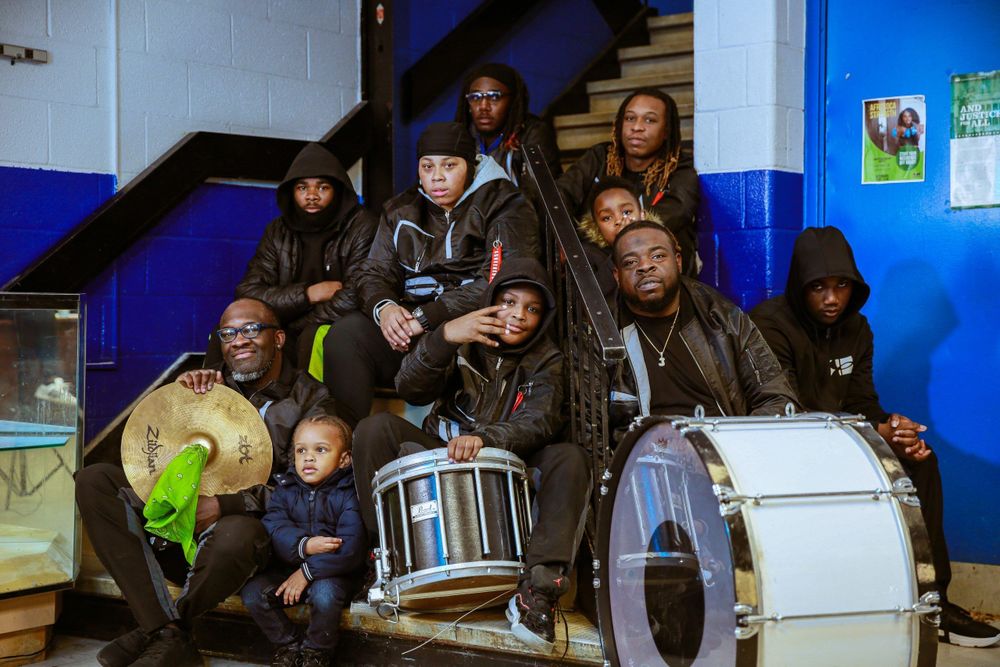 Members of a band pose for a photo with their instruments.