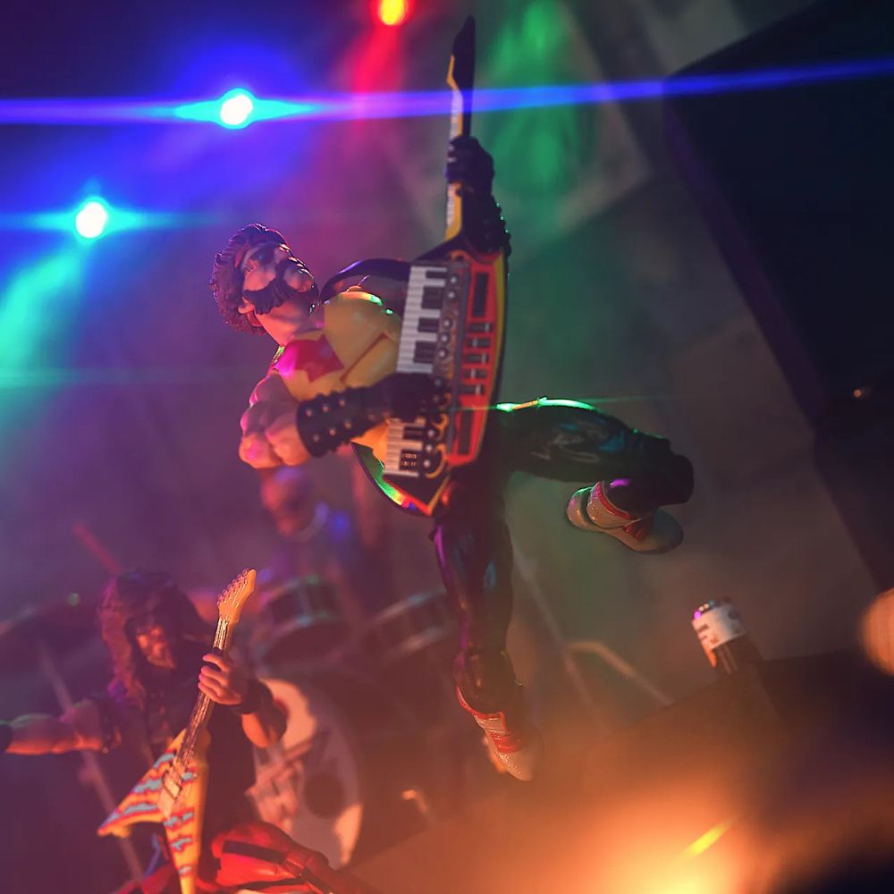 Dreadnok Torch in Cold Slither glam rock Disguise jumping through the air playing keytar.