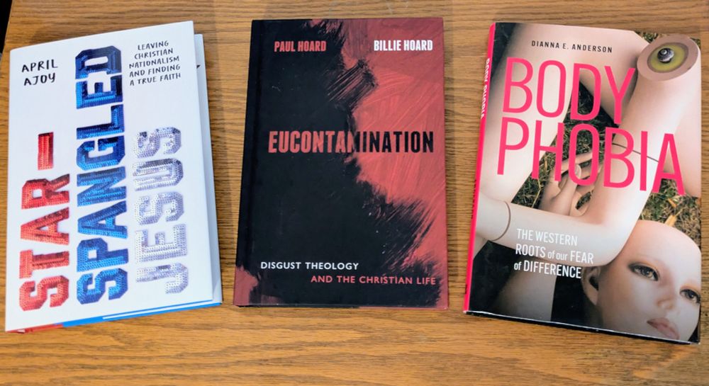 3 books on a table: Star-Spangled Jesus by April Ajoy, Eucontamination by Paul and Billie Hoard, and Body Phobia by Dex Anderson 