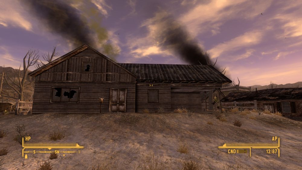 A dilapidated house with smoke in the background from Fallout New Vegas 