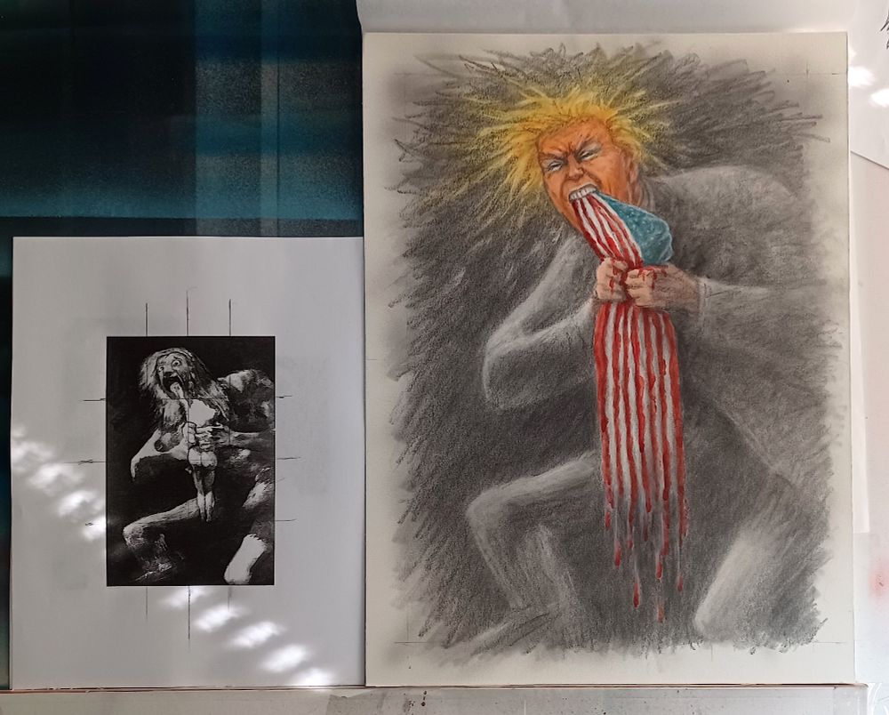 a photo of my art desk with work I finished over the weekend. A Xerox reference picture of Goya's "Saturn Devouring His Children" sits to the left on my work replacing Saturn with trump, and substituting the American flag with the child Saturn is feasting on. The flag's red stripes drip blood.