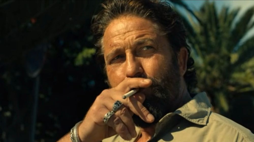 Gerrard Buttler at the end of Den Of Thieves 2 smoking a cigarette 