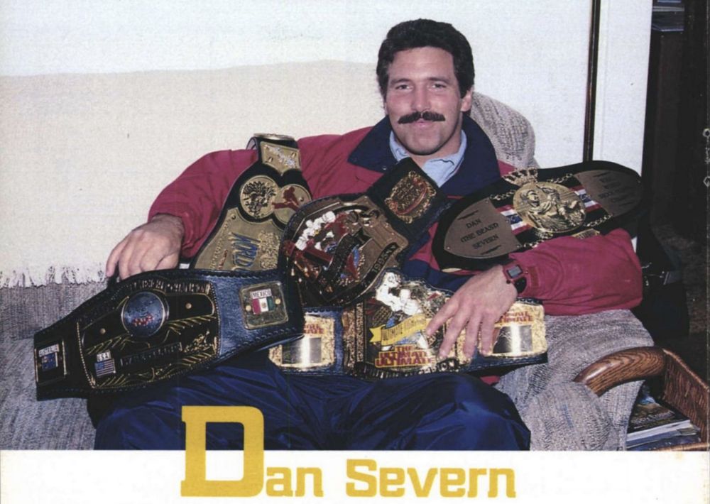 Dan Severn with a bunch of title belts. 