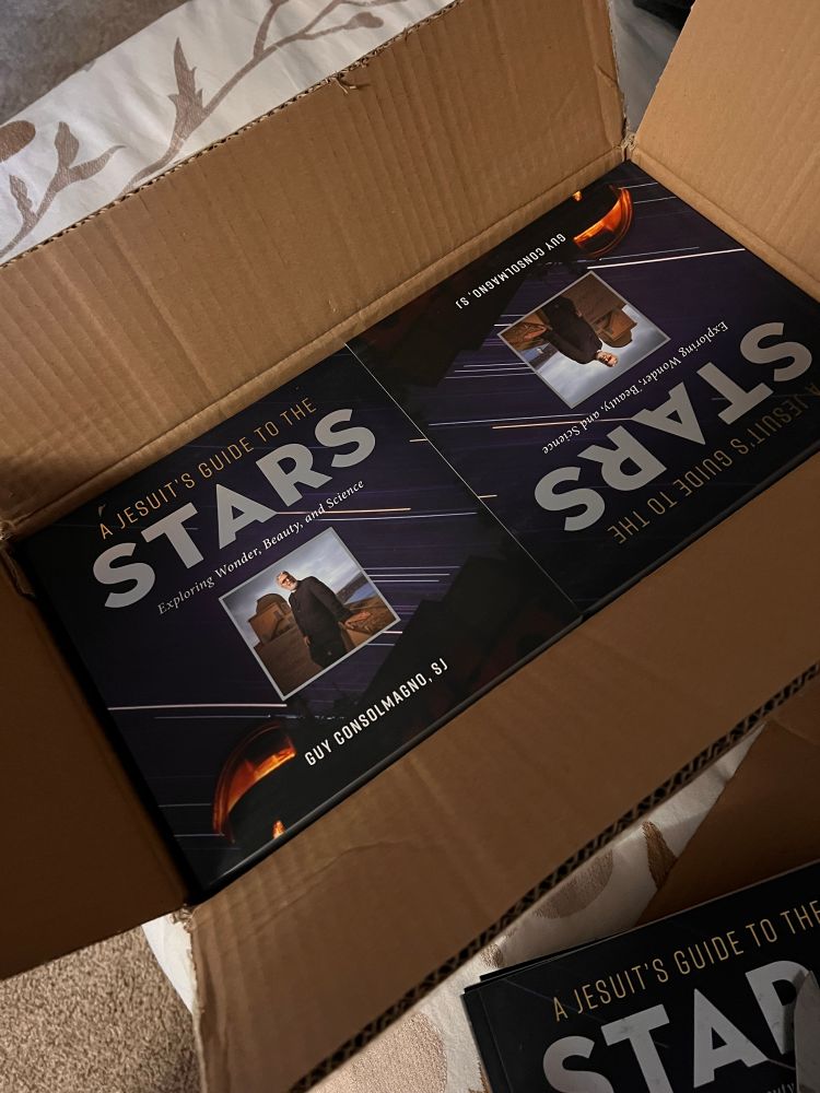 Box filled with copies of the book A Jesuit’s Guide to the Stars 