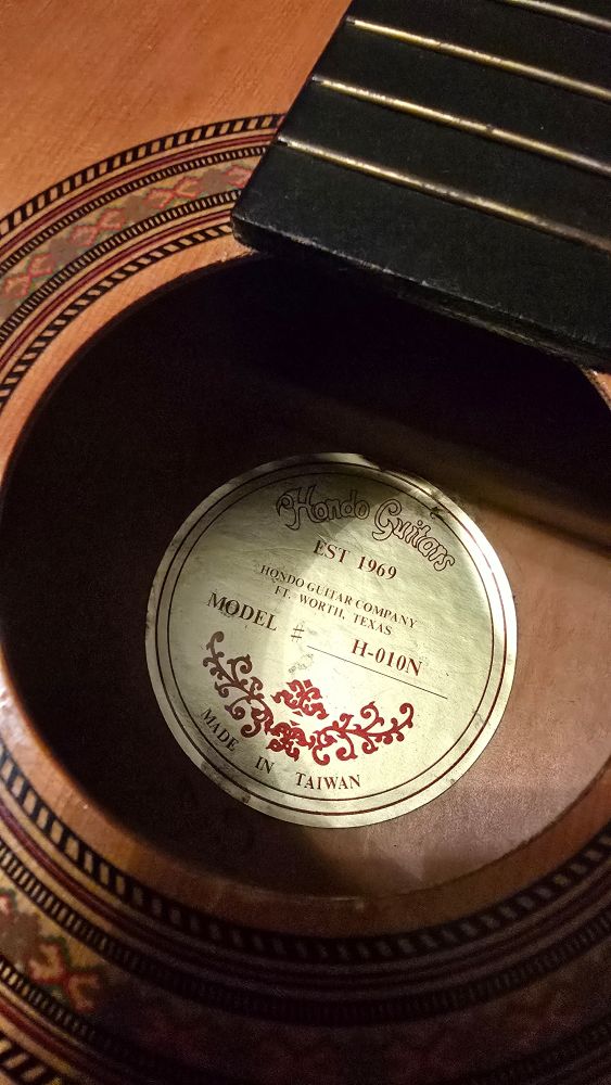 Label sticker reads "Hondo Guitars, EST 1969, Hondo Guitar Company, (Fort) Worth, Texas. Model # H-010N. Made in Taiwan."