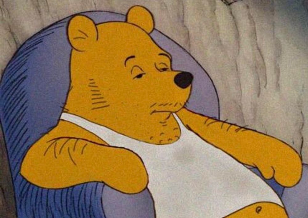 Pooh in a white tank sitting on the couch