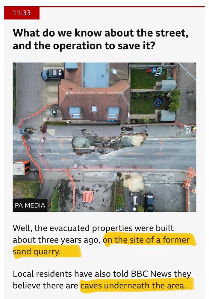 A screenshot from BBC news about a sinkhole in southern England. The arial picture shows a collapsed street and multiple barricades. The text says that the area is built on a former sand quarry. 