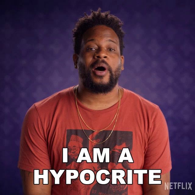 a man wearing a red shirt that says " i am a hypocrite "