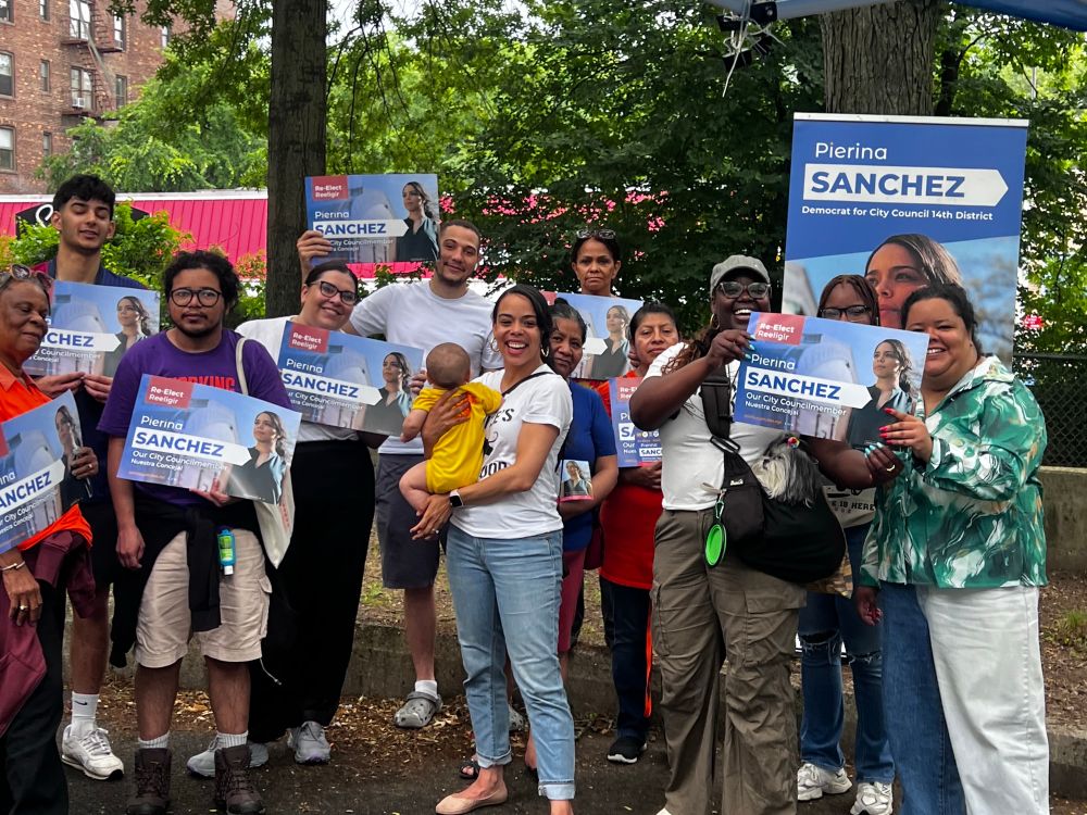 Crowd of volunteers from multiple groups stands around Bronx Councilmember Pierina Sanchez