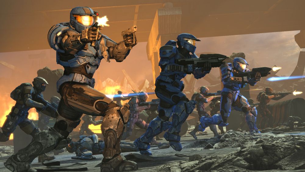 Three blue Mark IV Spartans fight alongside a bunch of Marines in a crumbling city.