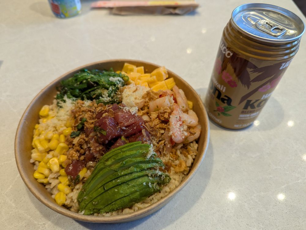 A Kona Hawaiian coffee can and poke bowl with rice, rolled egg, corn, avocado, ahi tuna and rice