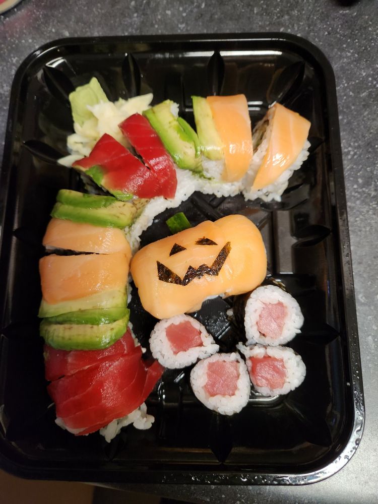 Store bought sushi, a pice of nigiri is styled like a jack-o-lantern