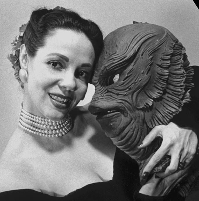 Creature designer Millicent Patrick holding her sculpt of the gill man mask in a publicity photo for Creature from the Black Lagoon (1954).