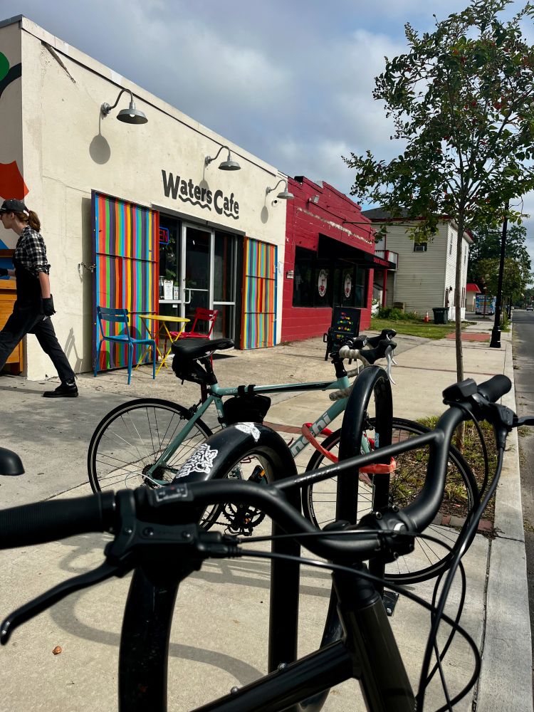 A photograph of bicycles locked to a bike rack in front of Waters Cafe on Waters Avenue in Savannah, Georgia.