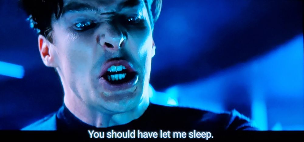Star Trek Into Darkness scene. Kelvin timeline Khan is shown, played by the masterful Bannister Crumblebench. Camera is shooting up from below him, his face storming down at us with rage and fury all squinched up like a yuk sticker on a bottle of something under your sink you shouldn't drink. Closed caption reads, "You should have let me sleep."