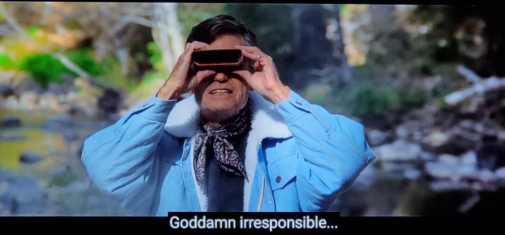 Star Trek V again, two in one day!! Bones, in a jaunty little jean jacket and ascot combo, is standing in nature. (moisturized, focused, flourishing.) Light campfire smoke wafts about behind him. He's holding up futurey space binoculars to his eyes, and just in general looks pretty pissed off. Closed caption reads, "Goddamn irresponsible.."