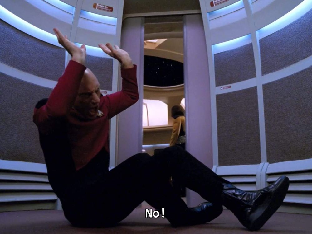 Star Trek The Next Generation scene. We've got a 4 picture special, and we're on the Enterprise in the turbolift off the bridge. The turbolift in the upper back, not the lower front one. 
Pic 1: From within the turbolift we see Picard on the floor, arms raised over head in fear, cowering, terrified. Caption reads, "No!"
Pic 2: Still in the turbolift but the door is now open, and Worf have come over to see what's up. Picard still doing a fright on floor but now looking up at Worf looking down at him. Caption reads, "Sir?"
Pic 3: Vantage point now from the bridge looking inward to the turbolift, Picard is standing with a very serious look on his face, and looking at Worf and bridge officers. 
Pic 4: Picard is speaking and exiting the turbolift, with several bridge officers looking at him. Closed caption reads, "As you were."