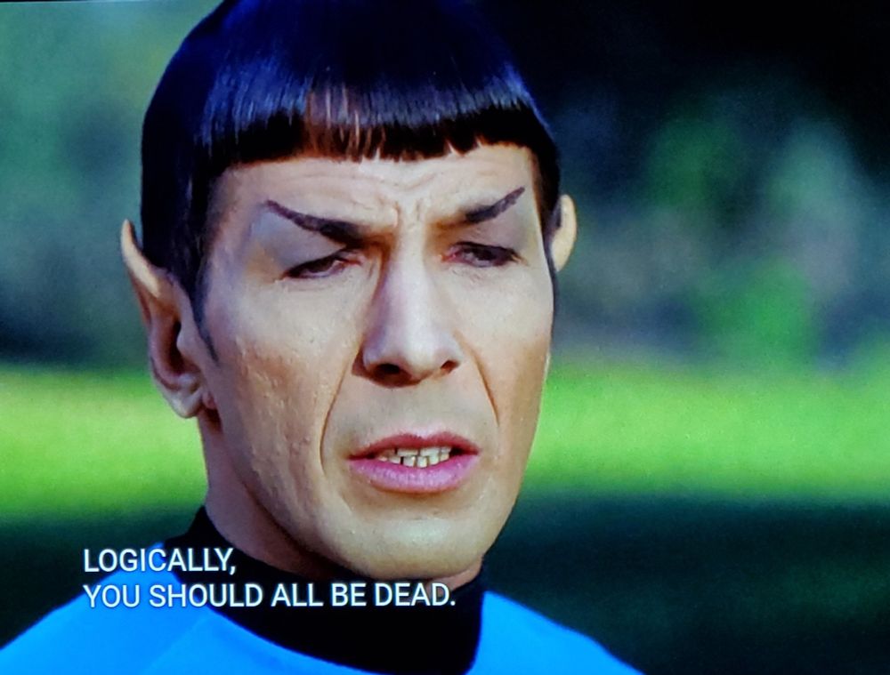 Star Trek The Original Series scene. Spock is outdoors in a green grassy but blurry kind of background. He's up close, making a face like he's mid-decision or maybe on the verge of a sneeze. Closed caption reads, 