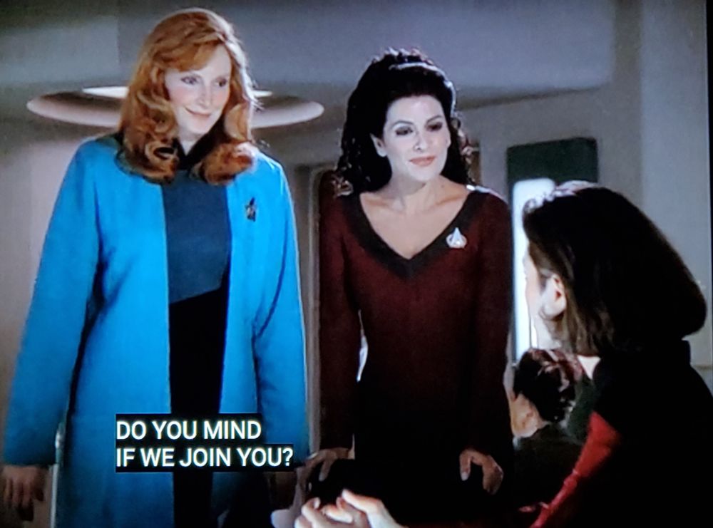 Star Trek The Next Generation scene. Four pictures! We're in Ten Forward which of course we all know is a future space bar on the Enterprise. 
Pic 1 shows Counselor Troi and Dr. Crusher looking warm and bubbly and happy approaching a table where Ro Laren is seated. Closed caption reads, "Do you mind if we join you?"
Pic 2 shows an unenthusiastic Ro Laren looking up at them with no F's to give and stone faced. Pic 3 is still on Ro, now looking straight down at her drink, closed caption reads, "Yes."
Pic 4 is back on Troi and Crusher. Crusher has a forced smile, and Troi is wide eyed and shooketh. 