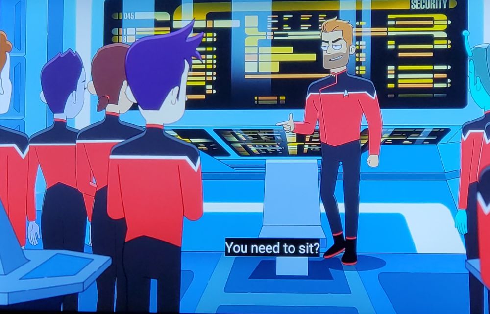 Star Trek Lower Decks scene. We're on the bridge of the USS Cerritos, a fine ship. Not the best ship, no, but a fine ship. 
Picture one: Ransom stands in front of a group of crew members holding court next to the captains chair. Closed caption reads, "You need to sit?"
Picture two: Ransom now has one leg extended over top of the chair, Riker style. Closed caption reads, "Cross your leg over the back of it and slam down."
Picture three: Now sitting (man spreading) in the captains chair, Ransom flexes and arm and looks cocksure. Boiler looks back awkwardly and unsure of all of this. Closed caption reads, "Command that chair."