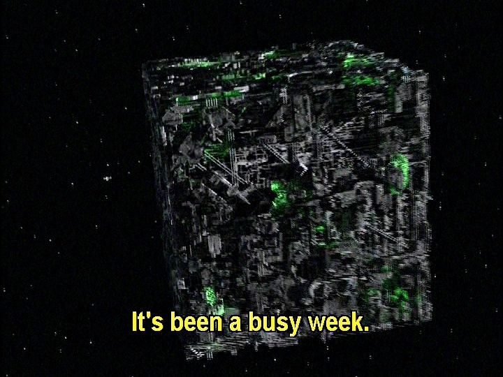 A Borg cube is pictured in space. Just sitting there. I don't think it's at warp because the stars aren't long lines, just spots. Closed caption reads, "It's been a long week."