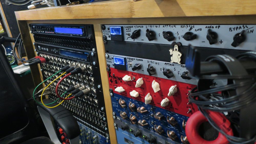 Two racks of audio equipment: lots of dials, lights and headphones, and a compressor called 'Ketchup 4000'