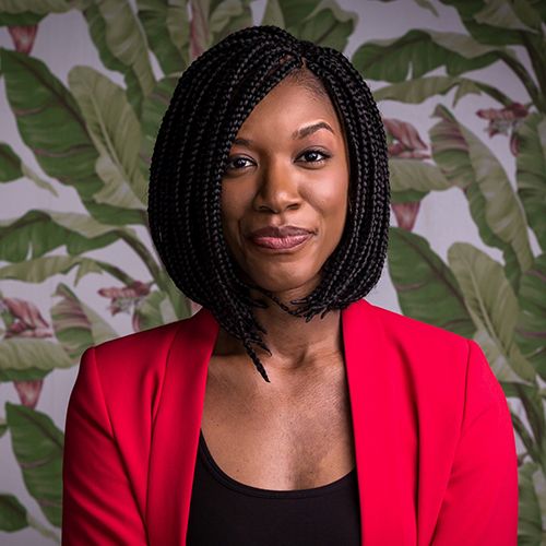 Photo of Dr. Jessica Pryce, smiling and looking directly at the camera, with a pained leaf pattern in the background