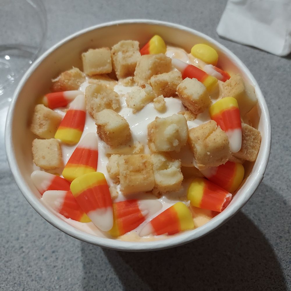 Pumpkin and cheesecake swirled frozen yogurt covered with candy corn and cheesecake bites.