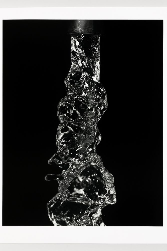 Black and white silver print of glass that looks like splashing water 