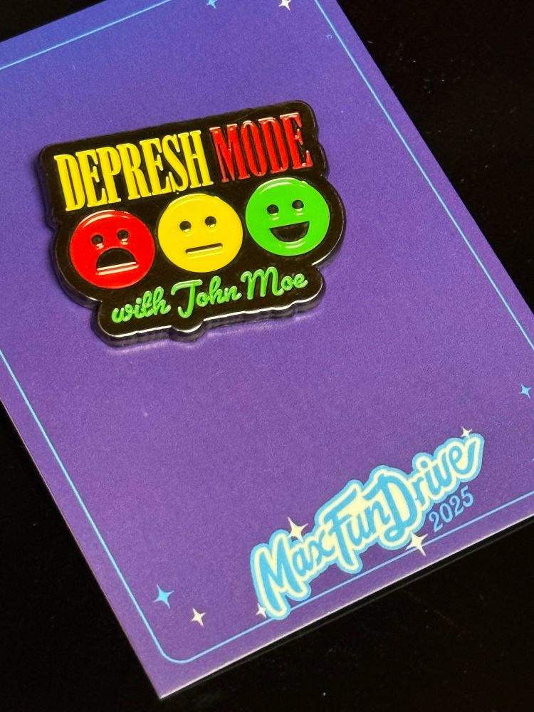 Pin from the podcast Depresh Mode. The pin is three faces, one angry, one calm and one happy. “Depress Mode with John Moe”  is above and below the faces. 