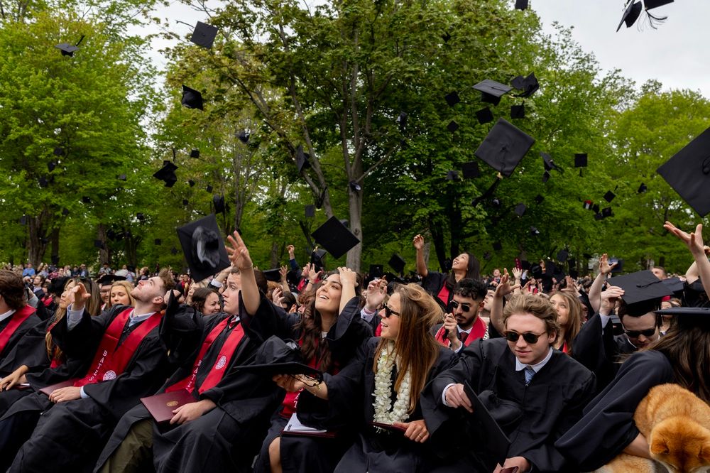 Members of the Bates Class of 2025 throw their caps in the air upon officially being named graduates of the college. 