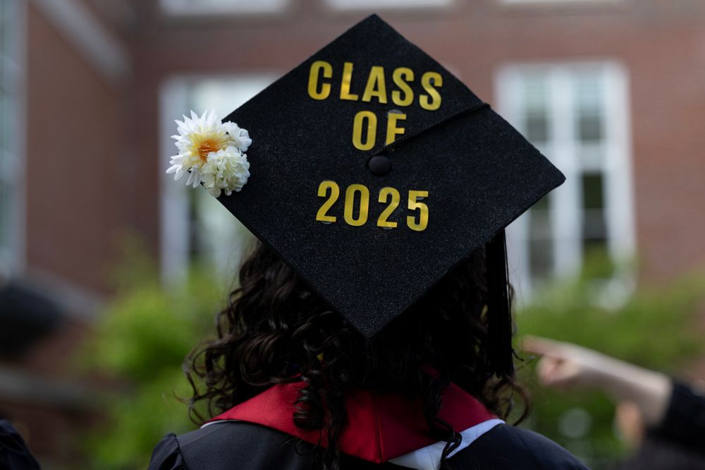 Close up on graduation cap that says Class of 2025 in golden letters with a flower on the left corner. 