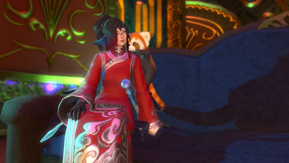 Character sitting on a couch with a tiny red panda on her right shoulder. She has a red dress one with black gloves. The dress has some fancy silver wave-like stuff on the bottom