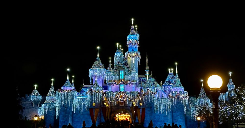 Castle at Disneyland lit up for Christmas yay