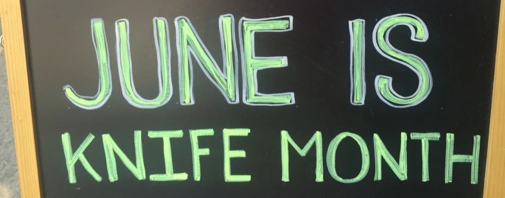 a chalk signboard reading "JUNE IS KNIFE MONTH"