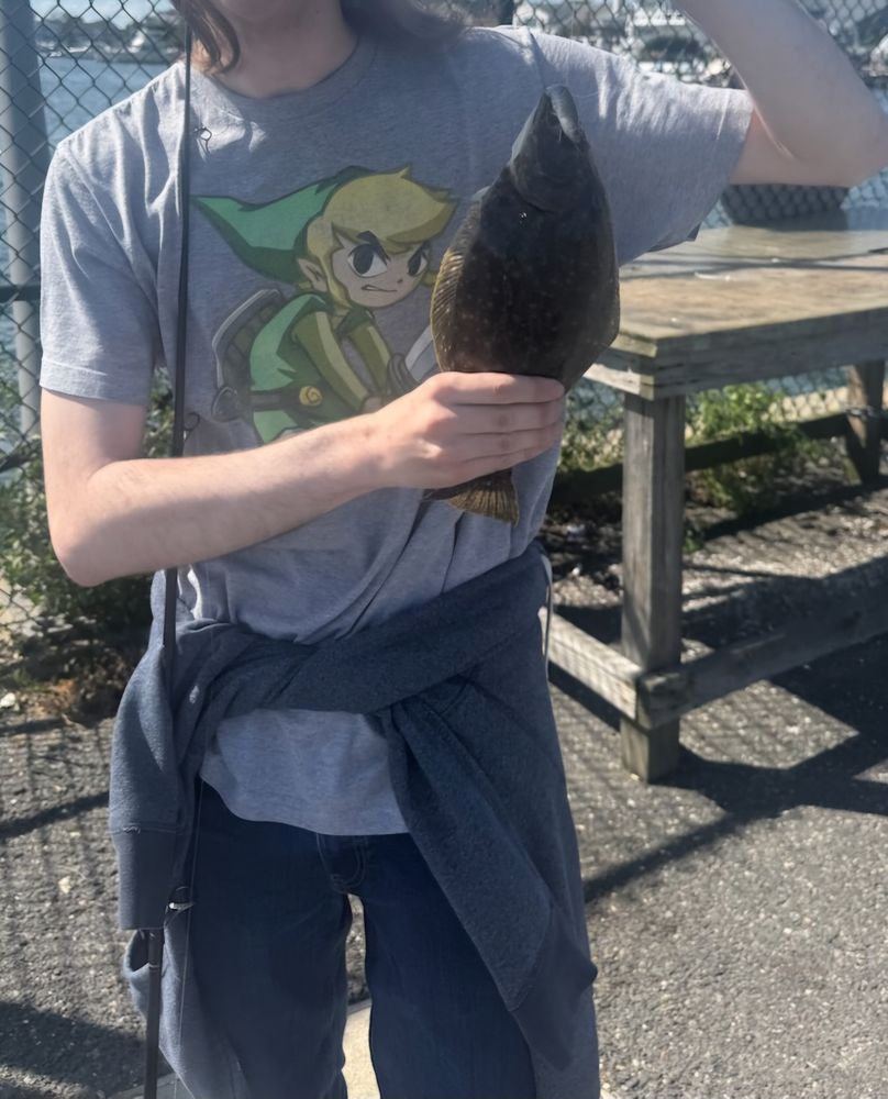 Me, holding a small (<12 in) flounder.