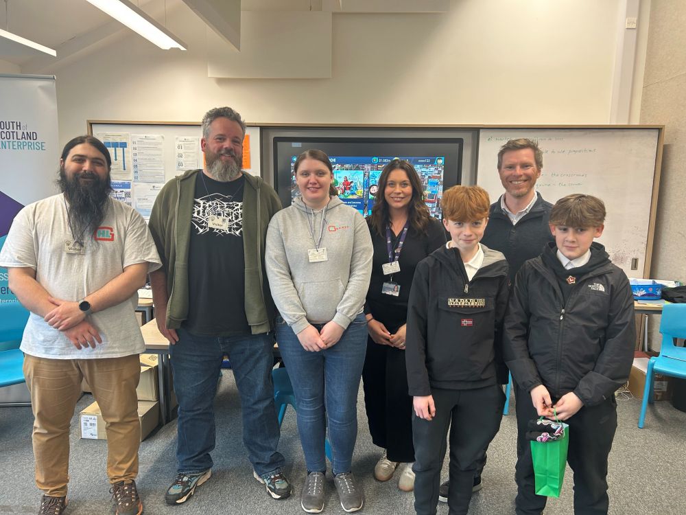 Team members from Hyper Luminal Games and South of Scotland Enterprise with two students from Dalbeattie High School