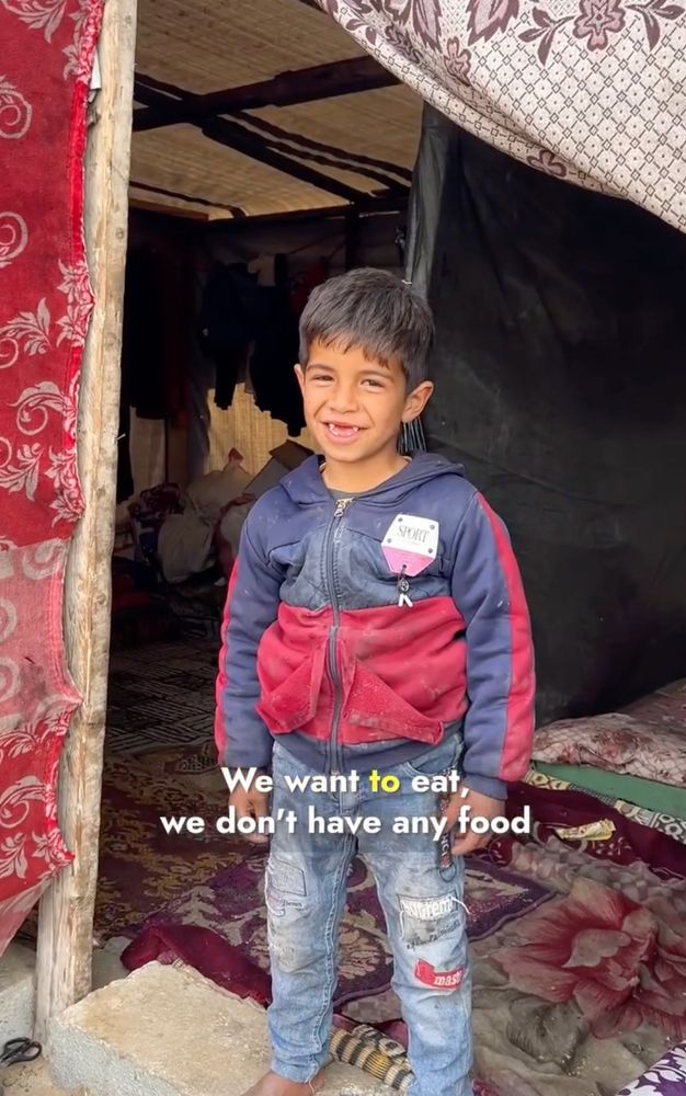 screenshot of small boy in front of his tent in N Gaza, with caption "We want to eat, we don't have any food"