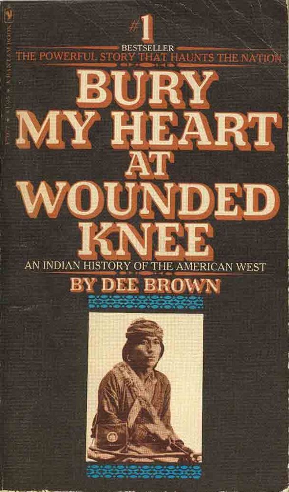 Brown cover with tan and orange title: Bury My Heart at Wounded Knee by Dee Brown. Below the title, a black-and-white photo of an Indigenous person appears.