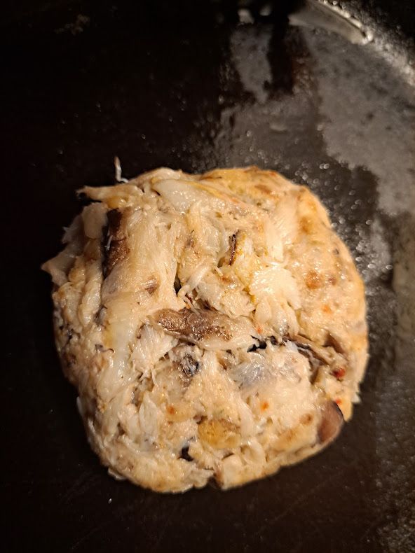blue crab claw meat crab cake in a cast iron pan