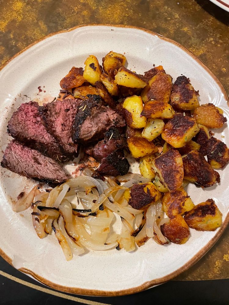 Grilled Steak, crispy herb potatoes, and grilled onion