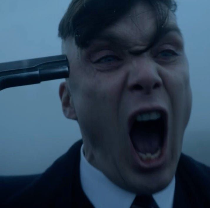 screenshot from peaky blinders of a man with a gun to his head