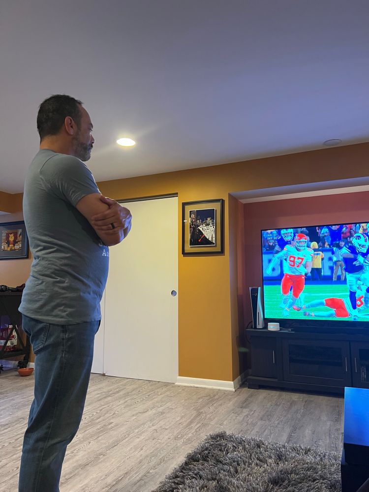 My husband watching the Bills game.