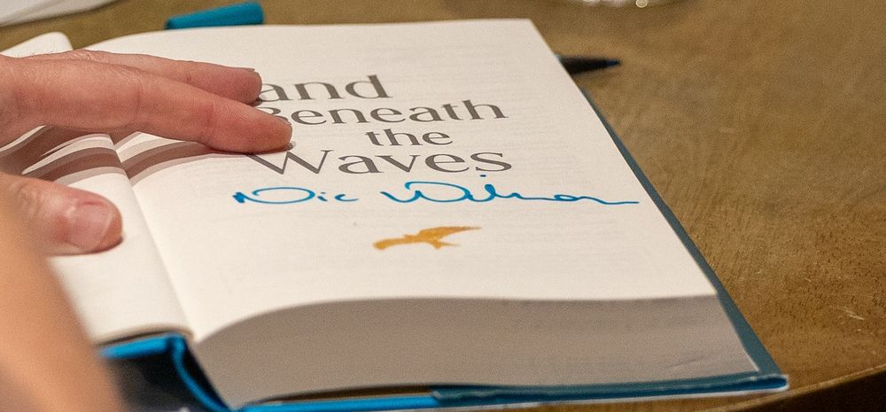 A page of a book with a signature on it.