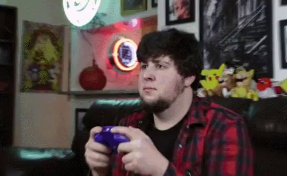 a man playing a video game with a purple controller